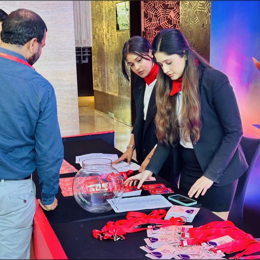 Hostesses running a lucky draw at a trade convention